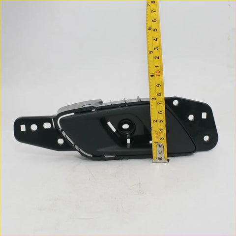 Black plastic inside door handle trim for ford ranger double cab 2012-2020 showing back side with mounting holes and opening