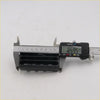 Black plastic vent trim for Mazda B2200 B2600 1985-2006 being measured with digital caliper