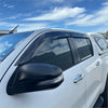 Black plastic window visors installed on white toyota hilux with bonnet guard matte black monsoon 2015-2020