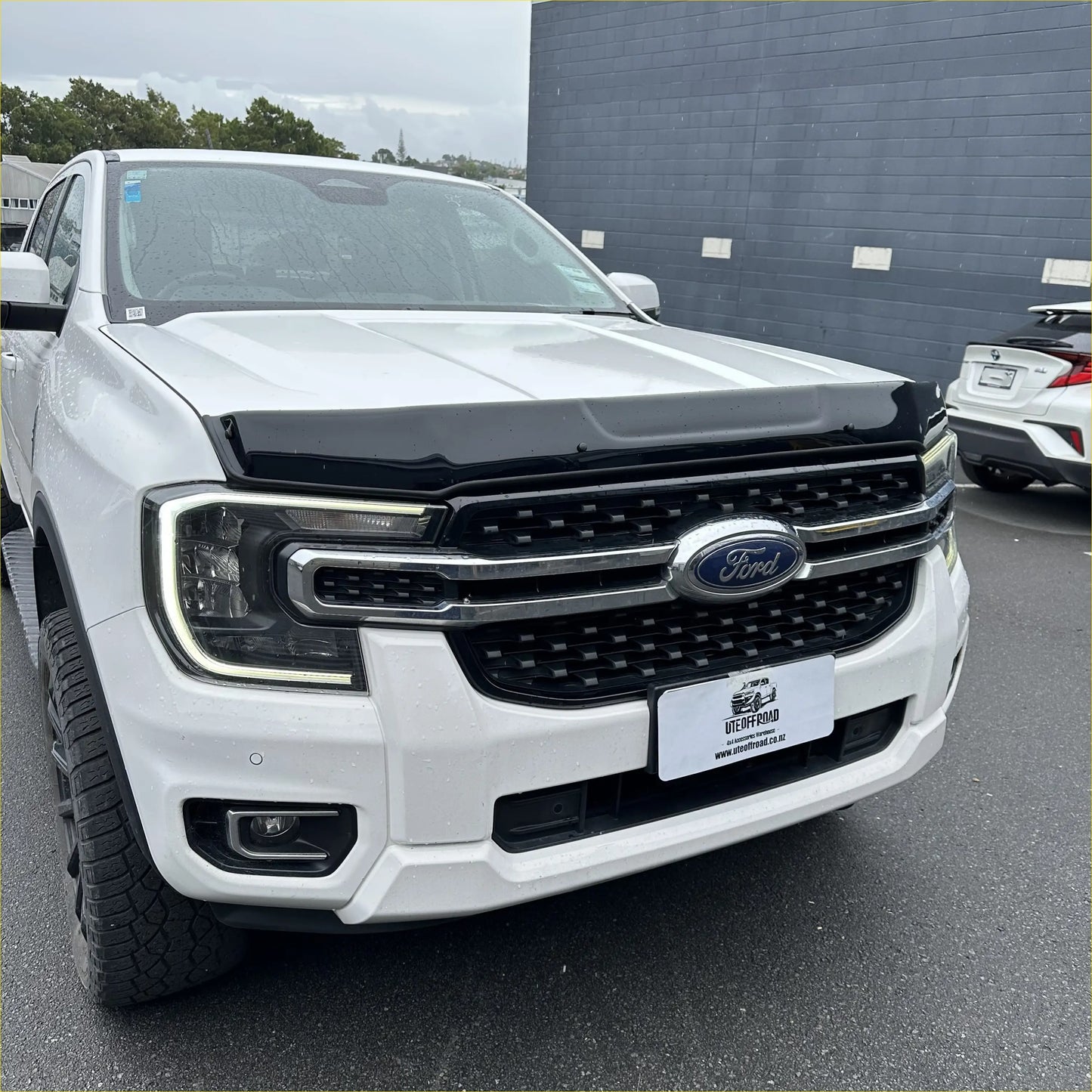 White ford ranger 2022 with black bonnet guard stone protector and chrome grille for new ranger models