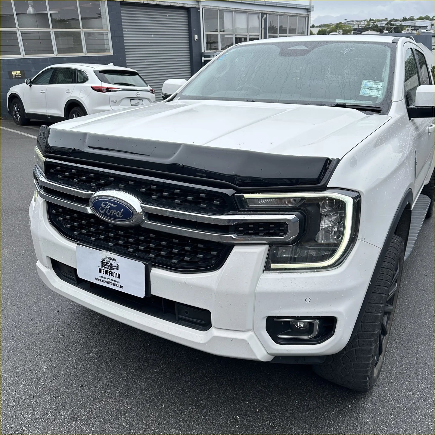 White ford ranger with black front grille and chrome accents featuring bonnet guard protector stone guard for 2022+ models