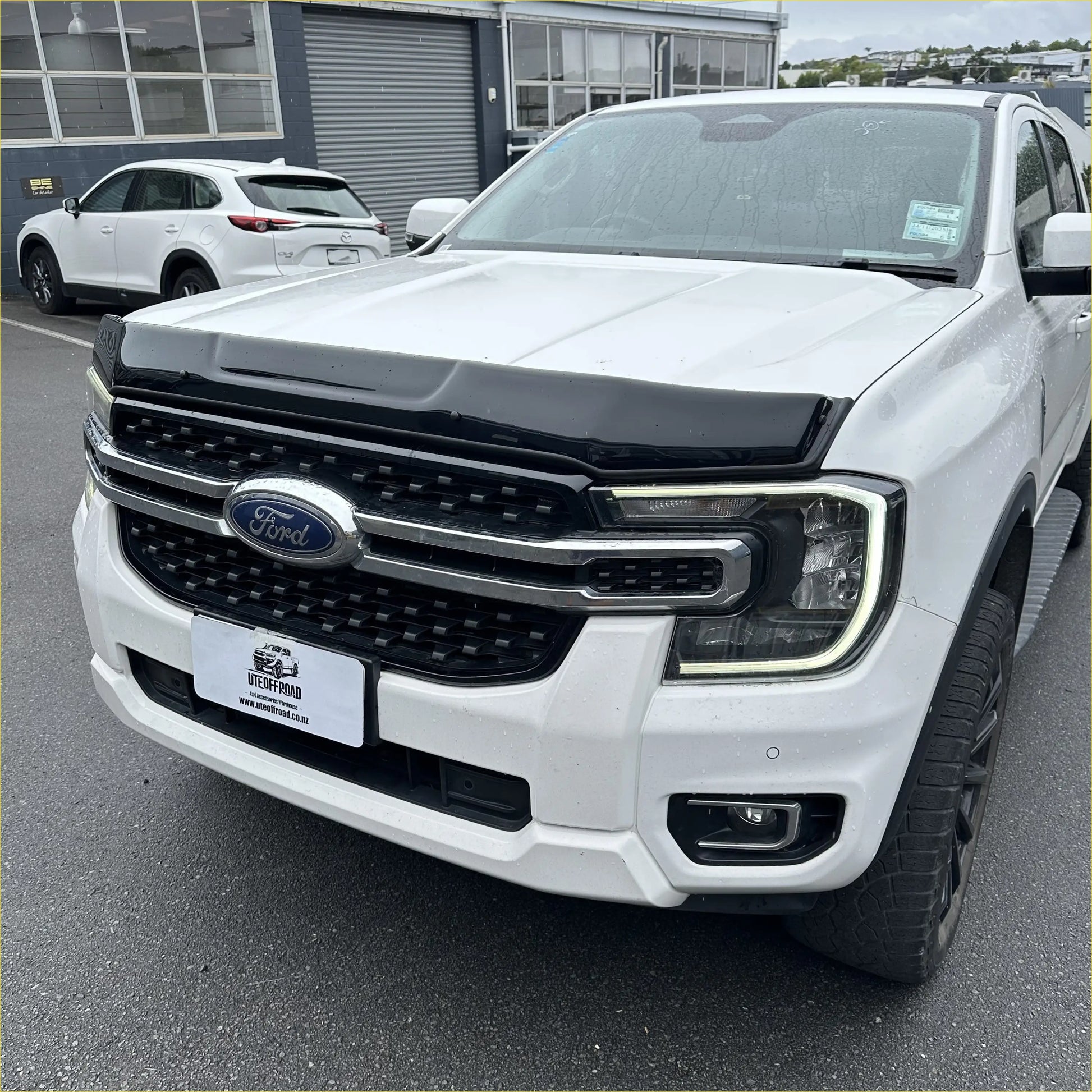White ford ranger with black front grille and chrome accents featuring bonnet guard protector stone guard for 2022+ models