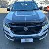 White and black holden ute with glossy finish and bold racing stripes featuring bonnet guard protector stone guard