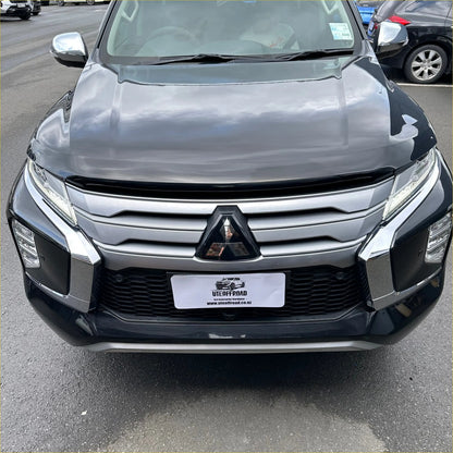 Black bonnet guard protector stone guard on mitsubishi triton suv with sleek grille and sharp led headlights