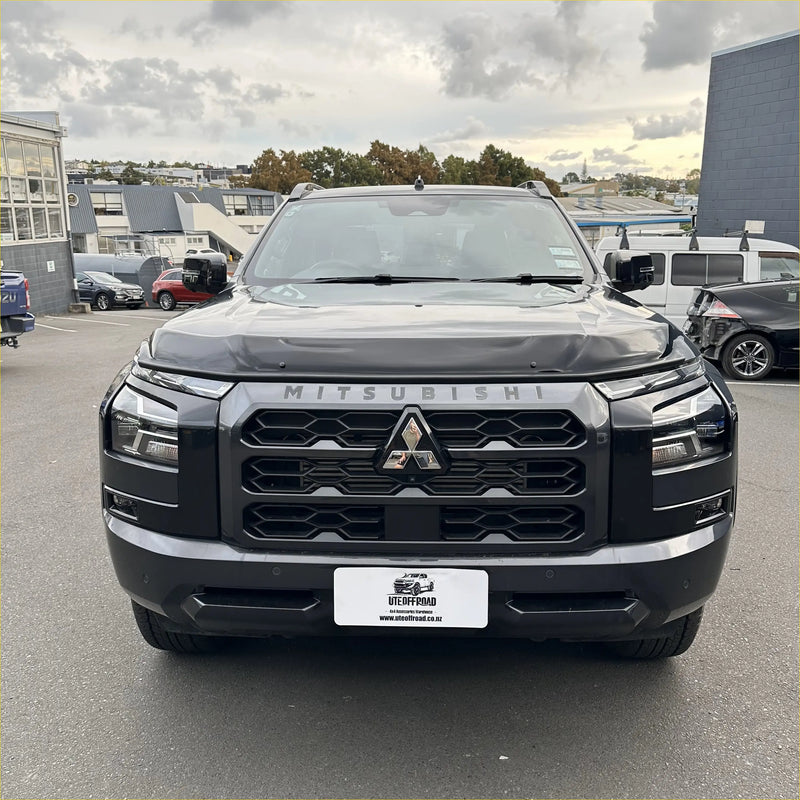 Black mitsubishi triton 2024 bonnet guard protector with bold angular grille and chrome accents stone guard