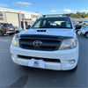 White toyota hilux pickup with black grille and roof rack featuring matte black bonnet guard protector stone guard
