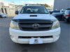 White toyota hilux with a matte black bonnet guard protector stone guard and black front grille and roof rack