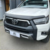 White toyota hilux pickup with matte black bonnet guard stone protector and chrome accents front bumper guard