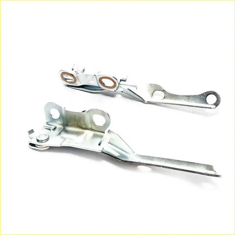 Silver metal bonnet hinge set for Toyota Hilux 1997-2005 with circular brass-colored rings and lever design latch assemblies