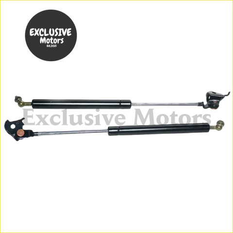 Black gas lift struts with metallic ends and cylindrical body for bonnet hood support on toyota land cruiser lc80