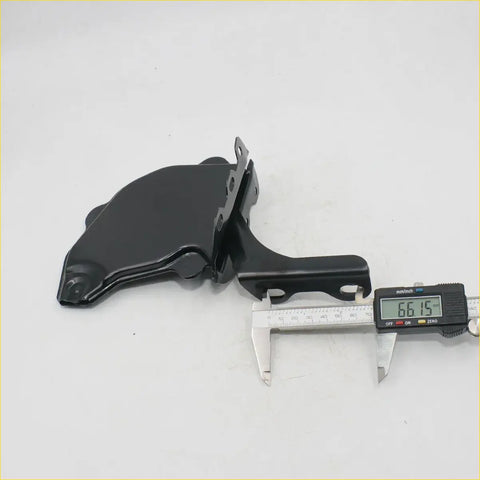 Black plastic bonnet lock hinge cover with sleek molded design and mounting brackets for toyota hilux 1984-1988