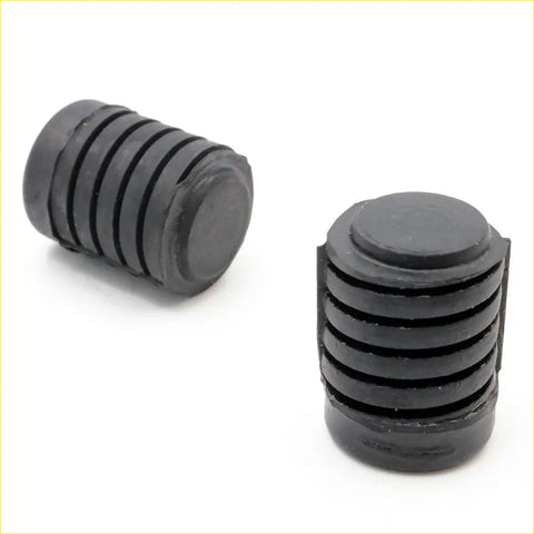Black rubber shock absorber caps with ribbed texture and circular ends for bonnet rubber bumper on nissan datsun 720 ute