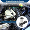 White plastic brake master cylinder reservoir with black rubber cap and metal fittings installed in toyota pickup engine bay