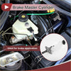 White plastic brake master cylinder with black cap and metal fittings installed in toyota avalon engine bay 2005-2007