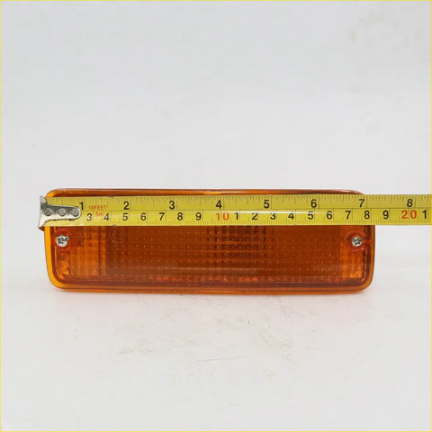 Orange rectangular amber bumper bar indicator light with clear plastic lens and metal brackets for Toyota Hilux 1988-1997