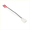 White plastic car speaker connector harness adapter with black and white wires ending in red insulated terminals for toyota pickup 1984-1988