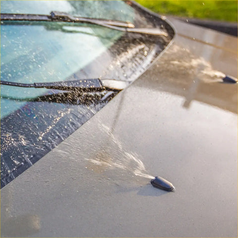 Black car windshield wiper blade and washer nozzle set spraying water on glossy black hood for toyota sienna 2004-2010