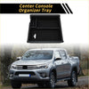 Black plastic center console organizer tray with molded compartments and handle for toyota tacoma 2016-2021