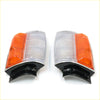 A pair of chrome corner indicator lightset for toyota hilux 1983-1988 with clear textured lens and orange reflector on black base