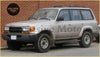 Silver Toyota Land Cruiser Prado FJ80 with black trim and roof rack featuring chrome side wind cover accessory