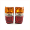 Pair of chrome tail lights with amber clear and red lens sections for Mitsubishi Ram 50 Strada 1987-1996