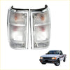 Chrome tail lightset for mazda b series bravo with chrome rectangular side marker lights and clear textured lenses showing red and white elements