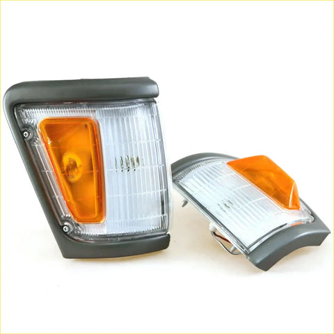 Pair of black-framed rectangular corner indicator lights with clear lenses and orange turn signals for toyota hilux 1988-1997