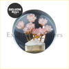A crystal transparent flower gear shift knob with a clear glass dome encasing pink flowers and gold stems on a textured base