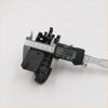 Black plastic door handle bezel gray for toyota hilux sr5 being measured with digital caliper on the back side
