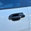 Black matte-finish door handle cover fitted on white ford ranger 2022+ new ranger vehicle close up