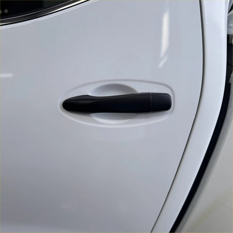 Matte black door handle cover on white nissan navara np300 2015-2020 with smart key system visible