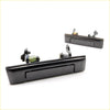 Black plastic door handle with spring mechanism and mounting hardware for toyota hilux 1984-1988 back side view