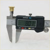 Black digital caliper with silver jaws measuring a brass door hinge pin for Toyota Hilux MK3 1972-1997 kit