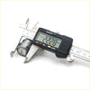 A black digital caliper with silver metal body measuring a metal lock cylinder for Toyota Hilux Ute door lock keys