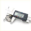 A shiny chrome door lock cylinder being measured by a digital caliper for mitsubishi delica 1986-1999