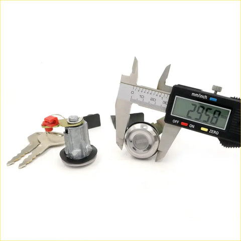 Shiny chrome door lock cylinder with matching keys and digital caliper measuring diameter for mazda rx4 929 sedan