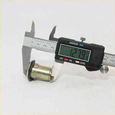 A brass finish metallic door lock cylinder with black rubber seal measured by digital caliper for nissan datsun 720