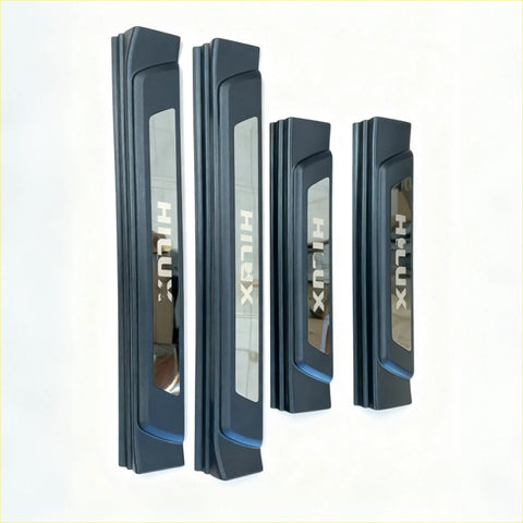 Set of four black plastic door sill protectors with silver hilux lettering for toyota hilux 2015-2025