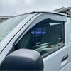 Black plastic door visor installed on a silver toyota hiace for weather protection and aftermarket style