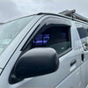 Black plastic side window door visor mounted on a silver toyota hiace 2005-2019 for weather protection