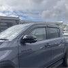 Black plastic door visors window monsoons weather shields installed on dark gray toyota hilux 2015-current