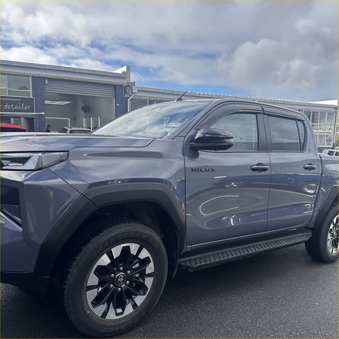 Gray metallic toyota hilux with black alloy wheels showing door visors window monsoons weather shields installed