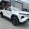 White toyota hilux with black wheels and side steps featuring door visors window monsoons weather shields 2015-current