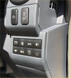 Gray plastic driver side switch fascia panel rhd with black buttons and white icons for climate and vehicle controls