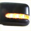 Black plastic electric door mirror with amber led turn signal for nissan navara d22 st-r dx terrano ute shown from back