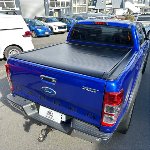 Black electric roller shutter tonneau cover on the back of blue ford ranger xlt px1 px2 px3 pickup truck