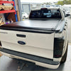 Black electric roller shutter tonneau cover on the back of a white ford ranger px1 px2 px3 pickup truck