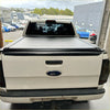 Black roll-up electric roller shutter tonneau cover on white ford pickup truck back side for mitsubishi triton 2024+