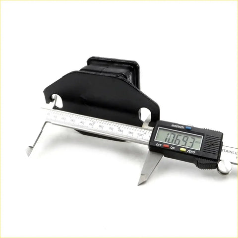 Black rubber engine mount support for toyota hilux 4runner 1988-1997 being measured with digital caliper
