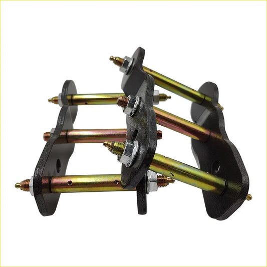 Black metal bracket with three gold rods and silver bolts for extended greasable shackles 2 inch 50mm lift kit